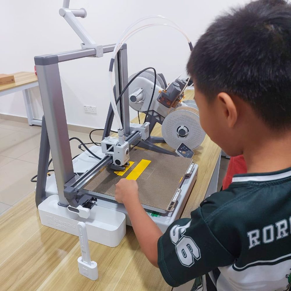 A child at the 3D printer at Kunoa